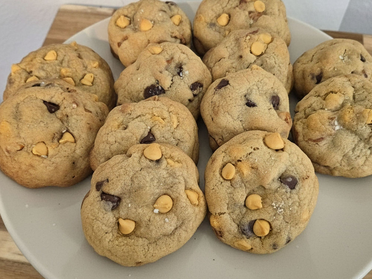 A plate of Salty Butterscotch Chocolate Chips Pretzel Cookies arranged on a light gray plate.